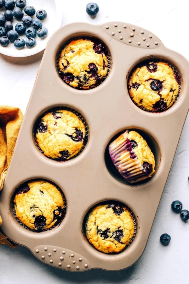 A 6-muffin tin with 6 baked muffins.