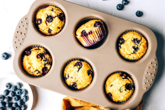 A 6-muffin tin with 6 baked muffins.