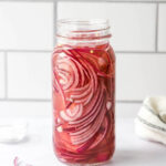 A jar containing quick pickled onions.