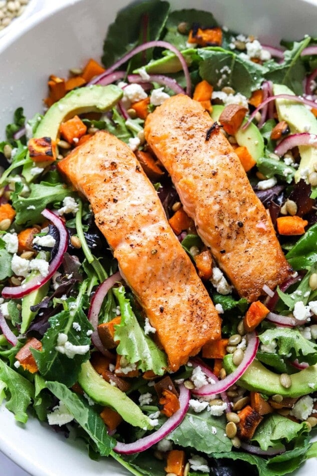 Two filets of salmon over a bed of superfood greens.