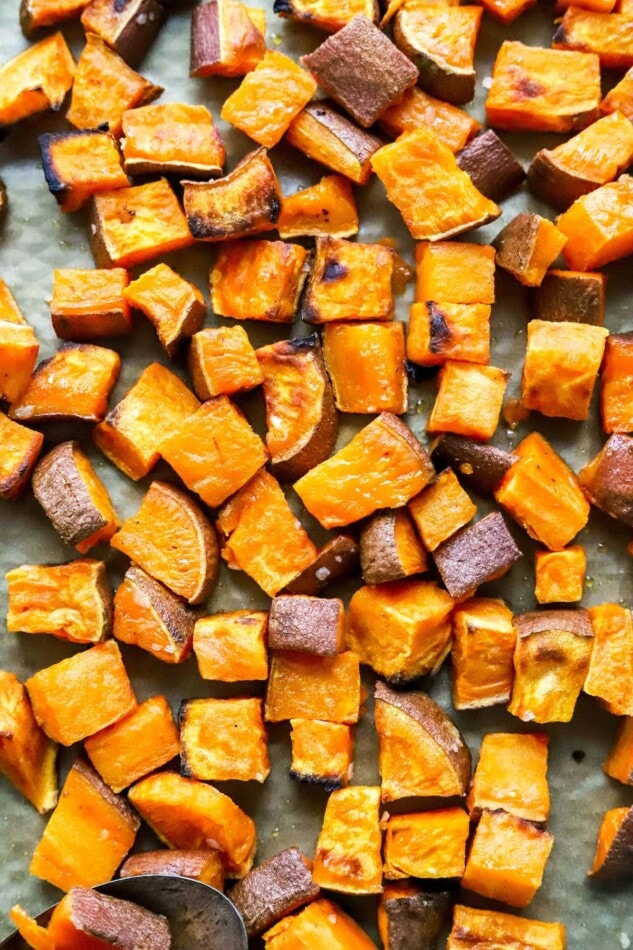 A close up of sweet potato croutons on a baking sheet.