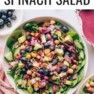 An overhead photo looking down at a bowl of spinach blueberry salad.