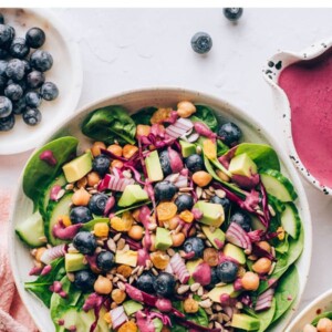 An overhead photo looking down at a bowl of spinach blueberry salad.