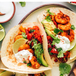 Three shrimo fajita tacos on a serving platter.