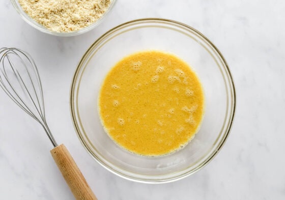 Eggs, almond milk, maple syrup, coconut oil and vanilla extract in a mixing bowl.