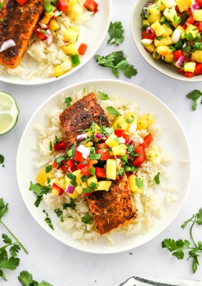 A filet of blackened salmon served over a bed of rice topped with pineapple salsa.