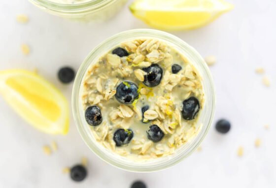 Ingredients for blueberry lemon overnight oats in a mason jar.