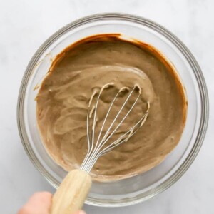 Whisking together ingredients to make chocolate protein pudding.