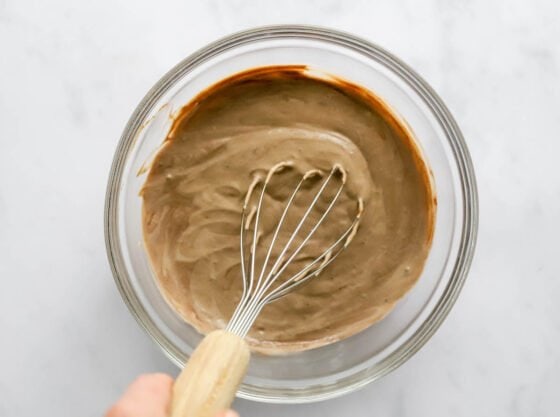 Whisking together ingredients to make chocolate protein pudding.