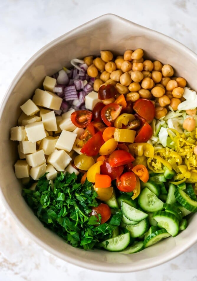 A bowl containing ingredients for Italian chopped salad.