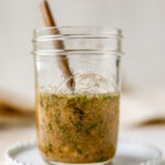 A mason jar containing homemade Italian dressing.