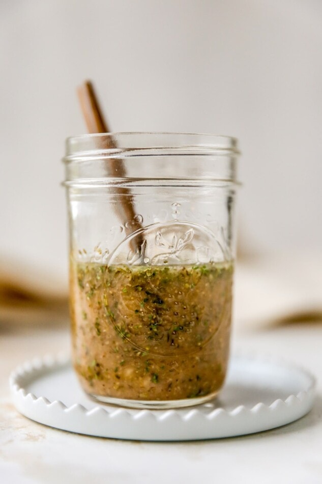 A mason jar containing homemade Italian dressing.