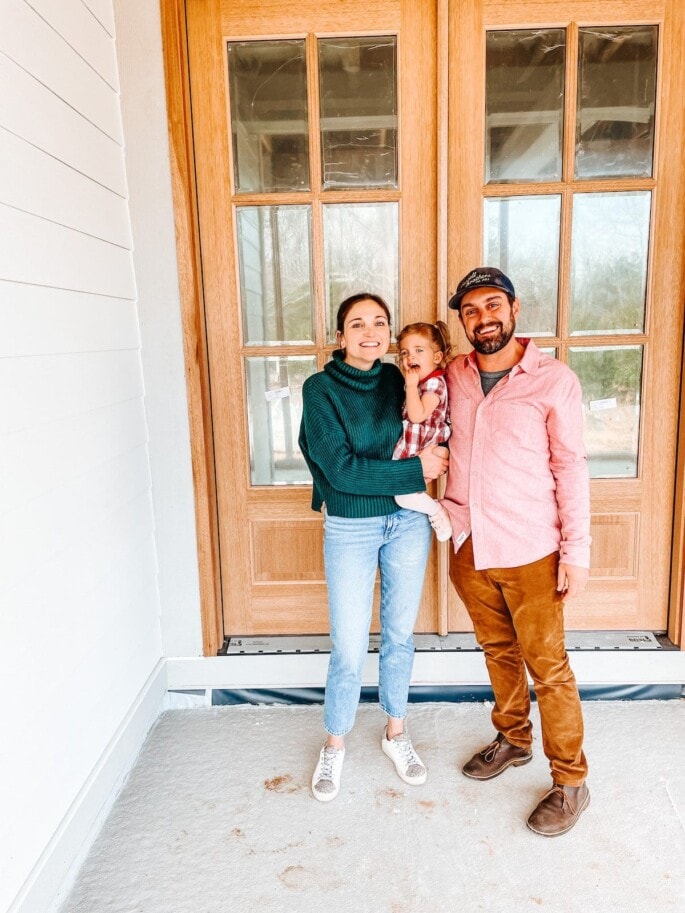 Family on the front porch of a house.