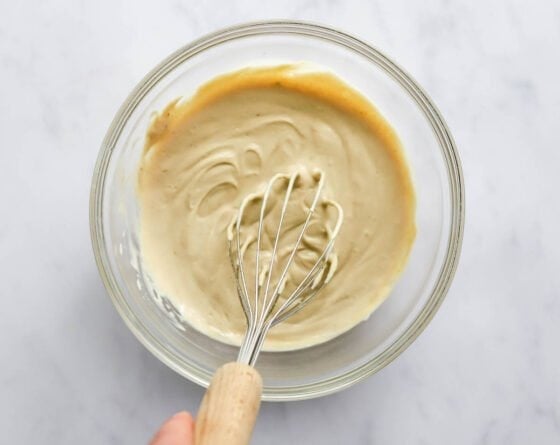 Whisking ingredients to make peanut butter protein pudding.