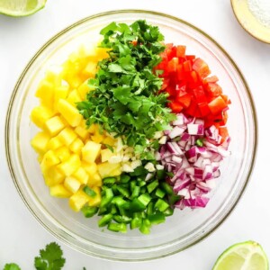 Ingredients for pineapple salsa in a mixing bowl.