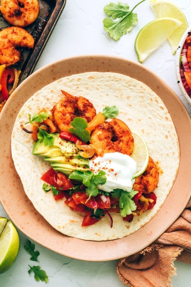 A single shrimp fajita on a plate.