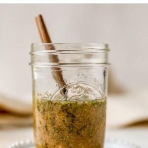 Homemade Italian dressing in a mason jar with a spoon.