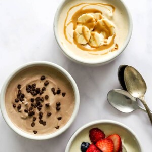 Three small dishes containing protein pudding 3 ways: peanut butter, chocolate, and vanilla.