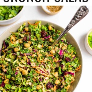 Sunflower crunch salad in a serving bowl with a serving spoon.