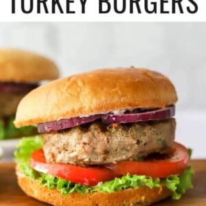 Turkey burger assembled on a bun with tomato, lettuce and red onion.