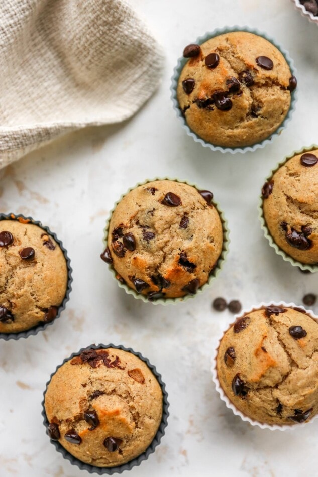 Overhead view of 6 chocolate chip yogurt muffins in silicone liners.