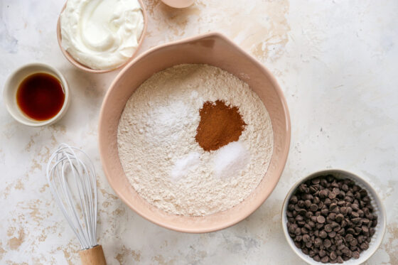 Flour, baking powder, baking soda, salt and cinnamon in a mixing bowl.