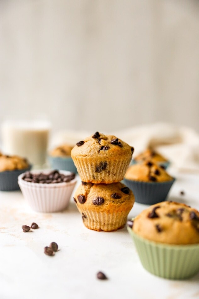 Two chocolate chip yogurt muffins stacked on top of each other.