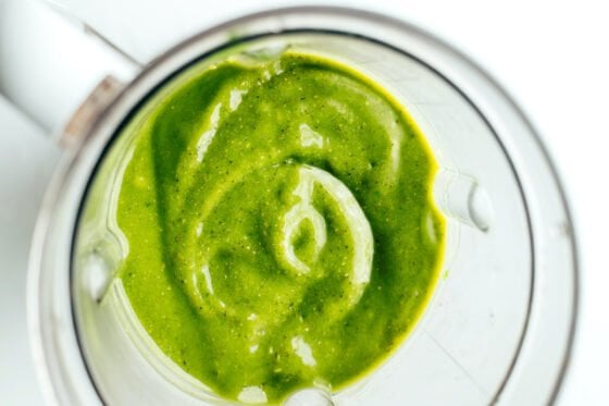 Ingredients for a green smoothie blended together in a blender.