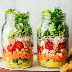 Topping mason jars with salad greens.