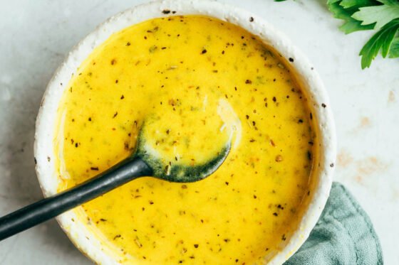 Nicoise salad dressing mixed together in a bowl.