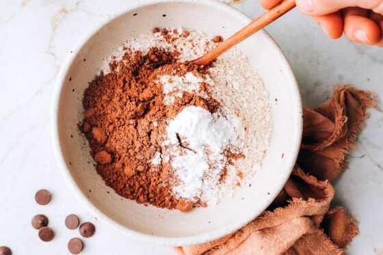 Mixing together oat flour, cocoa powder, sea salt and baking powder.