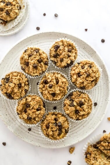 Oatmeal cups wrapped in paper liners on a plate.