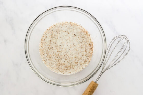 Almond milk and flaxseed mixed together in a bowl.