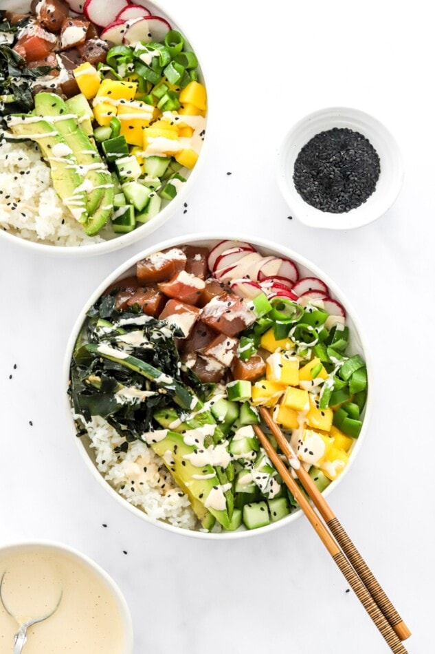 Overhead photo of two poke bowls. One has chopsticks.