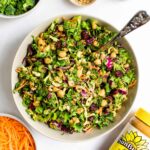 Overhead view of a bowl of sunflower crunch salad with a jar of SunButter sunflower seed butter.