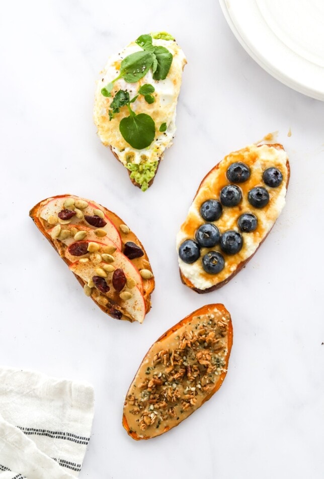 Four varieties of sweet potato toast scattered around on a counter top.