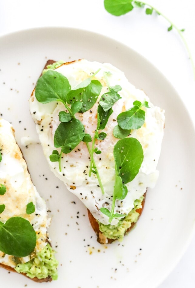 Avocado and egg sweet potato toast close up on a plate.