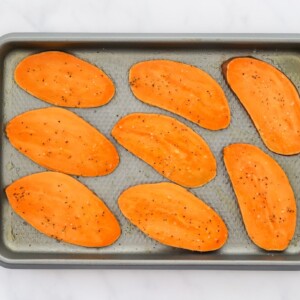 Sliced sweet potato on a baking sheet.
