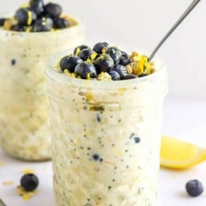 Jar of blueberry lemon overnight oats topped with blueberries and lemon zest.