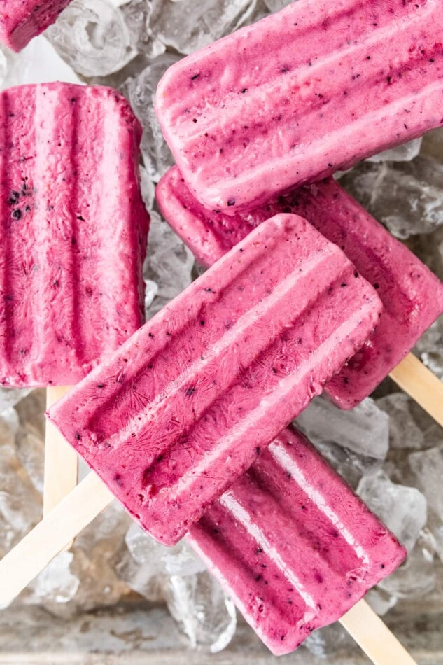 Close up of popsicles laying over ice.