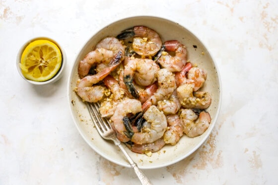 Shrimp marinating in a bowl.