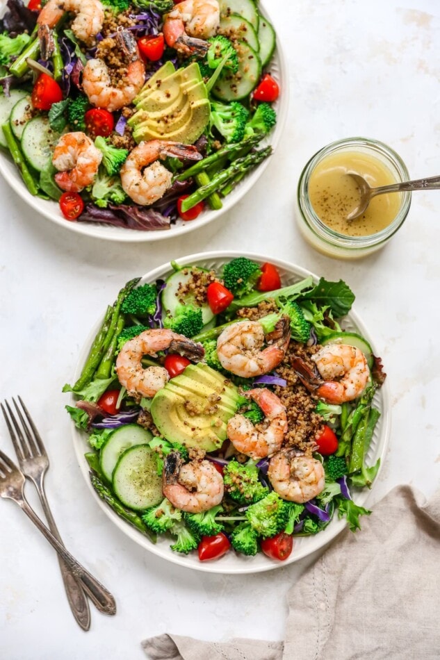 Two bowls of grilled shrimp salad.