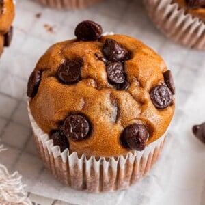 A protein muffin in paper wrapper.