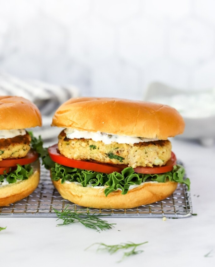 A salmon burger on a wire rack.