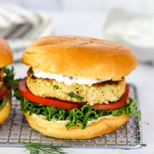 A salmon burger on a wire rack.