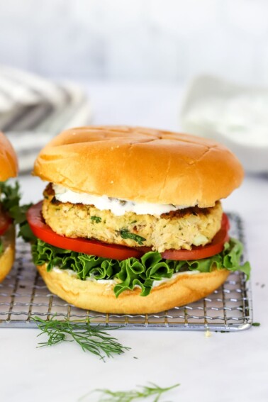 A salmon burger on a wire rack.