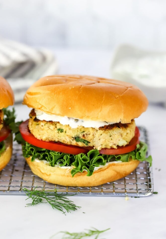 A salmon burger on a wire rack.