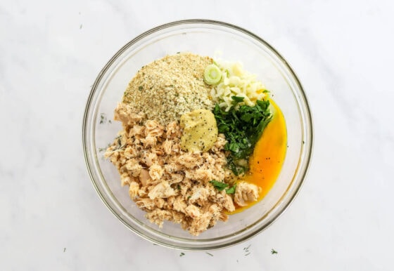 Salmon, bread crumbs, egg, garlic, scallions, dijon mustard, lemon juice, parsley, salt and pepper in a medium mixing bowl.