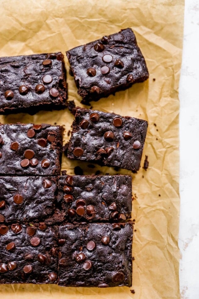 Zucchini brownies on a sheet of parchment paper.