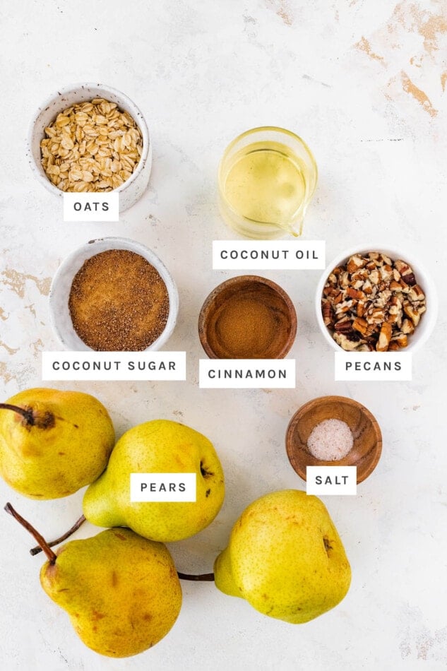 Ingredients measured out to make baked pears: oats, coconut oil, pecans, coconut sugar, cinnamon, salt and pears.